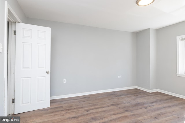 empty room with hardwood / wood-style flooring