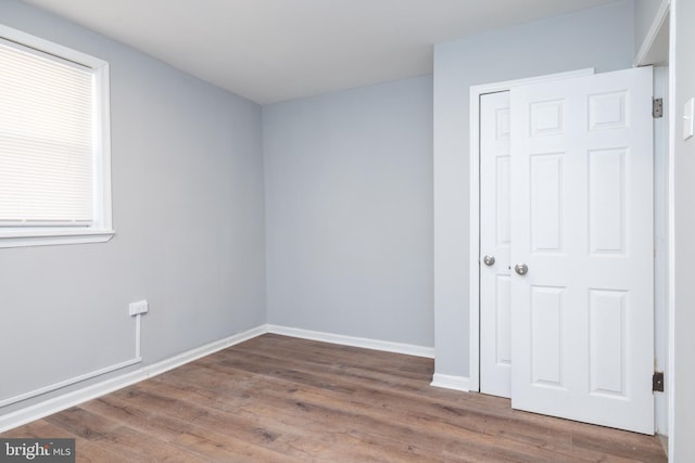 unfurnished room with dark wood-type flooring