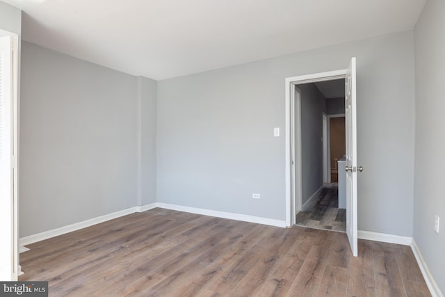 unfurnished room featuring wood-type flooring