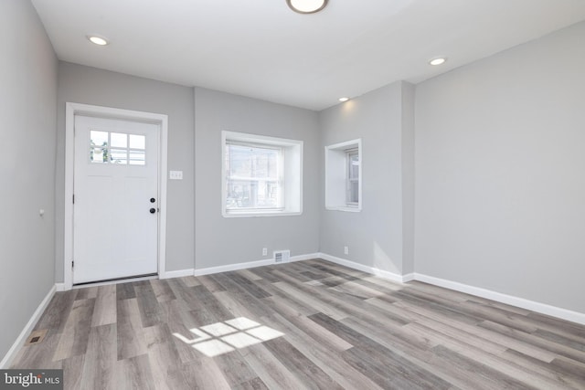 foyer entrance with light hardwood / wood-style floors