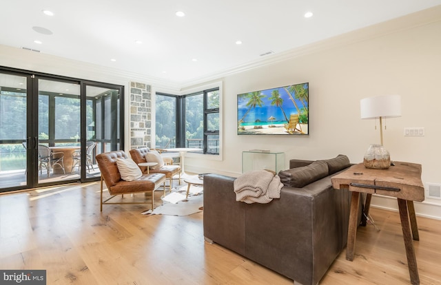 living room featuring light hardwood / wood-style flooring and crown molding