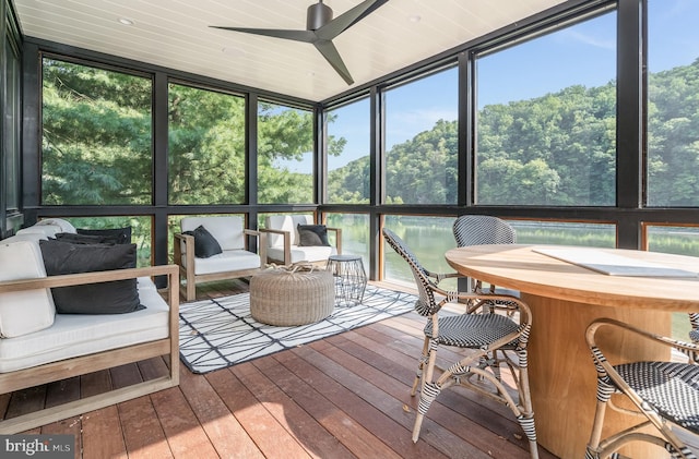 sunroom / solarium featuring ceiling fan