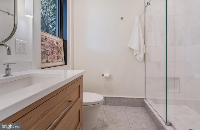 bathroom with tile patterned flooring, an enclosed shower, vanity, and toilet