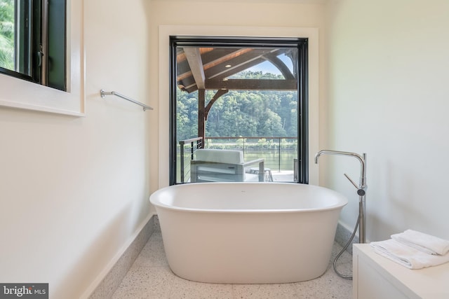 bathroom with a tub to relax in