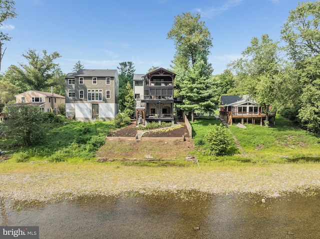 back of property with a balcony