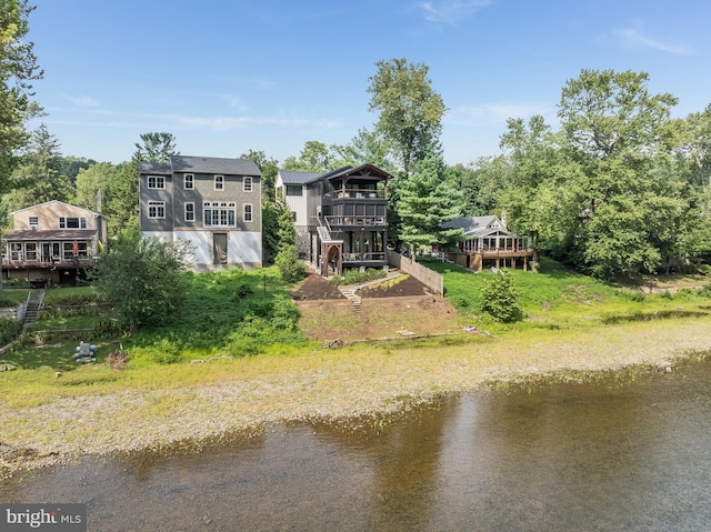 rear view of property with a deck with water view