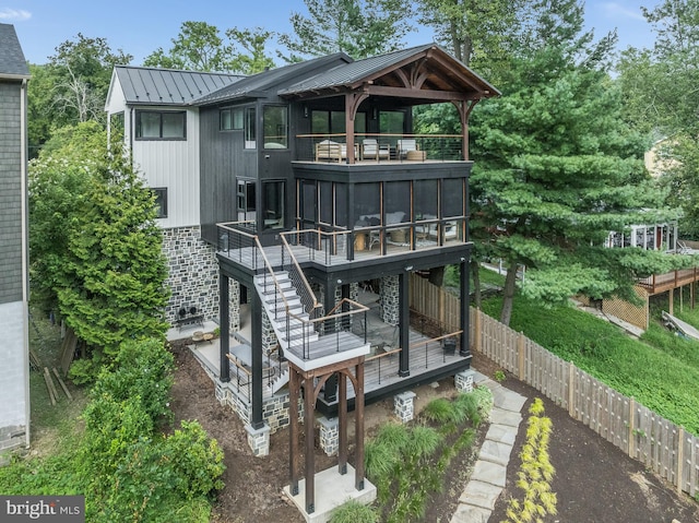 rear view of house featuring a gazebo and a wooden deck