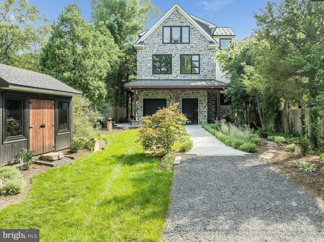 view of front of home featuring a garage and a front lawn