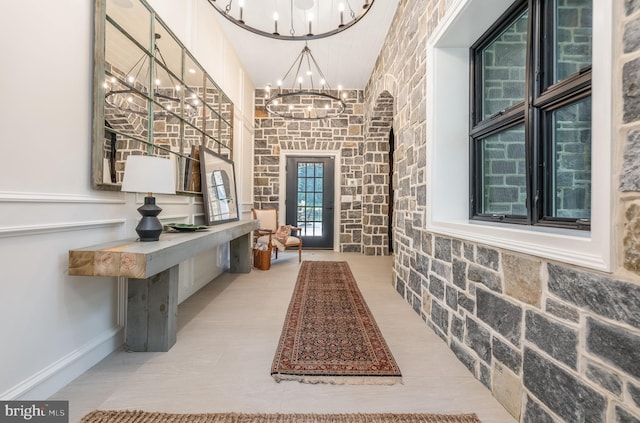 interior space featuring a high ceiling and a chandelier