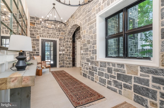 interior space with an inviting chandelier and a high ceiling