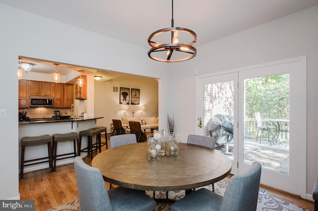 dining room with a chandelier and light hardwood / wood-style floors