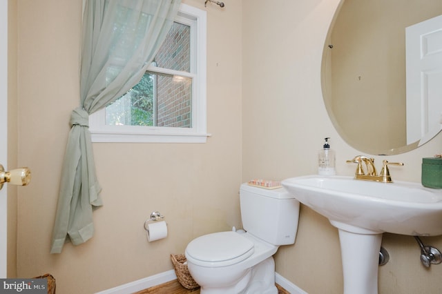 bathroom featuring hardwood / wood-style floors and toilet