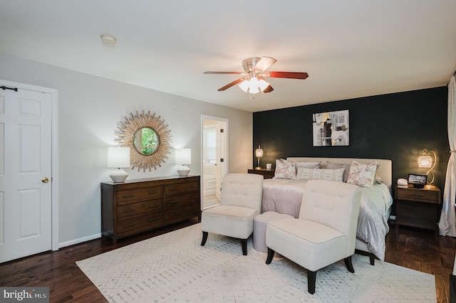 bedroom featuring dark hardwood / wood-style floors, ensuite bath, and ceiling fan