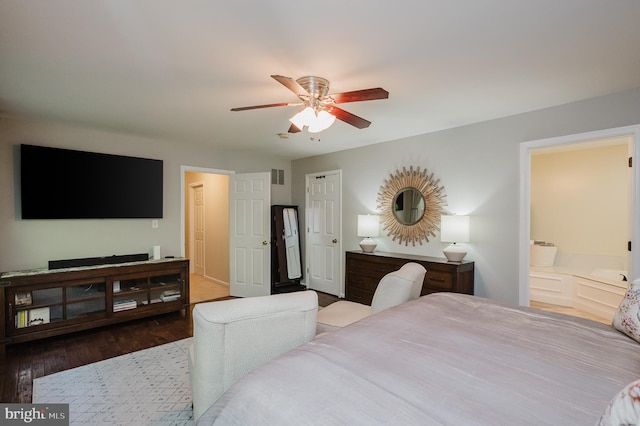 bedroom with ensuite bathroom, ceiling fan, and hardwood / wood-style flooring