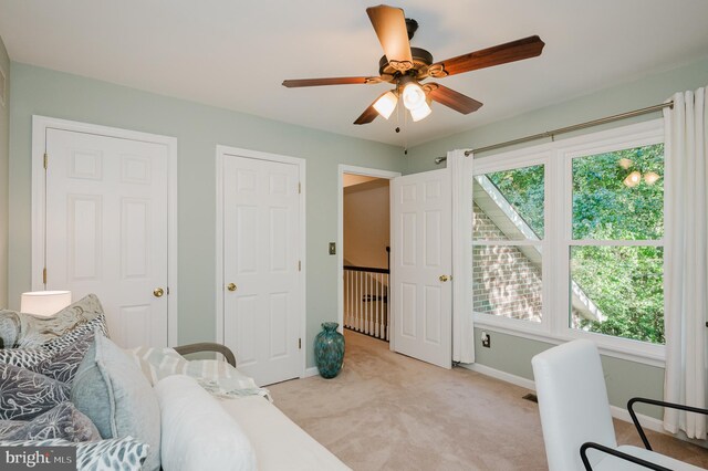 sitting room with ceiling fan, a wealth of natural light, and light colored carpet