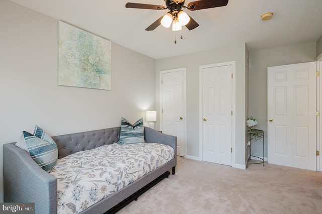 carpeted bedroom featuring ceiling fan