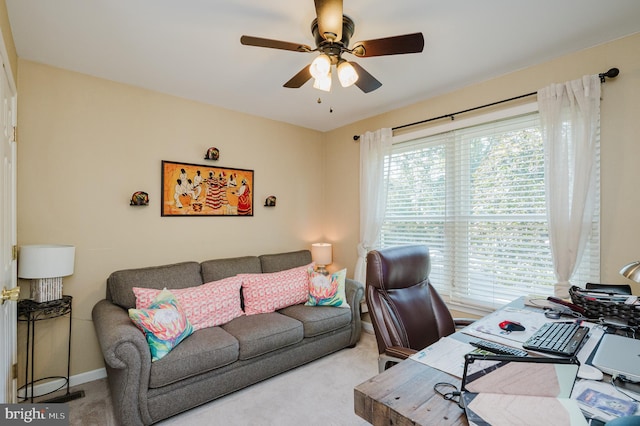 office space with light carpet and ceiling fan