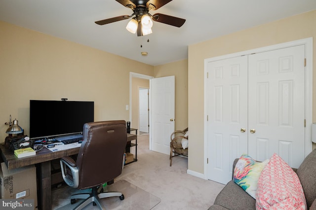 home office with ceiling fan and light colored carpet