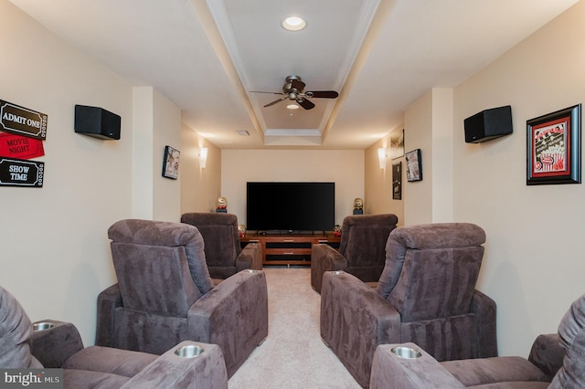 cinema featuring light carpet, a tray ceiling, and ceiling fan