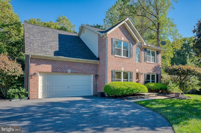 view of front of property with central AC unit and a garage