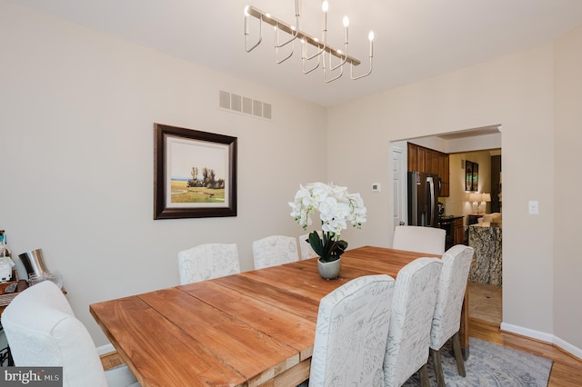 dining room with a notable chandelier and hardwood / wood-style flooring