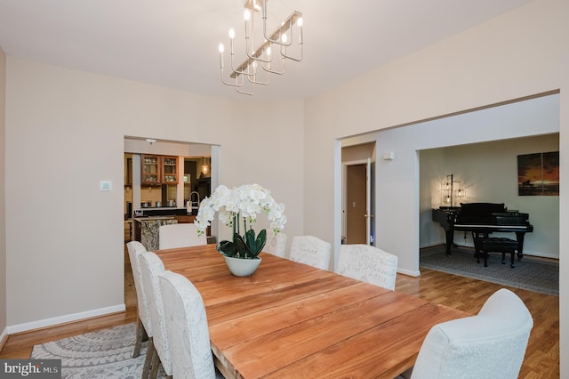 dining room with a notable chandelier and hardwood / wood-style floors