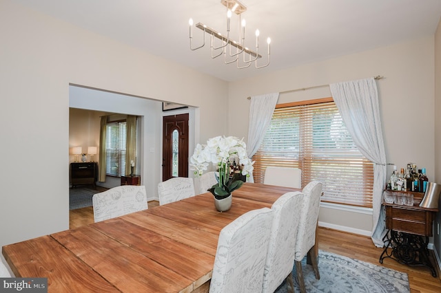 dining room featuring hardwood / wood-style floors and a chandelier