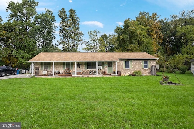 ranch-style home featuring a porch and a front yard