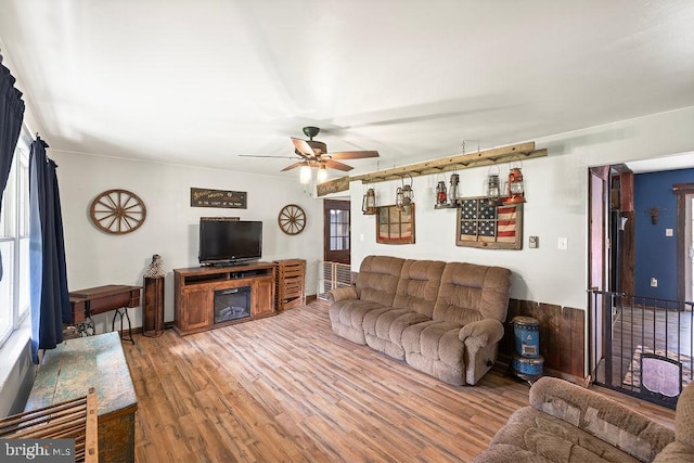 living room with ceiling fan and hardwood / wood-style flooring