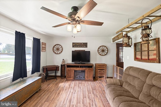 living room featuring wood-type flooring and ceiling fan