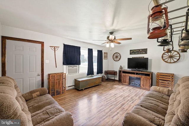 living room with a fireplace, baseboard heating, cooling unit, ceiling fan, and hardwood / wood-style flooring