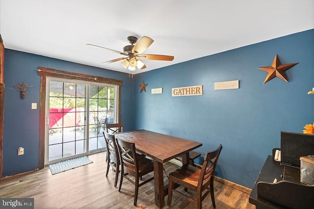 dining area with hardwood / wood-style floors and ceiling fan