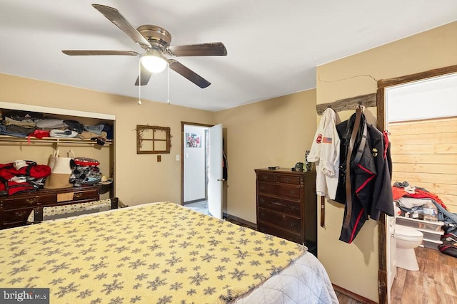 bedroom featuring wood-type flooring, ceiling fan, and a closet