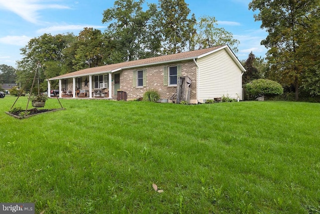 rear view of house with a lawn