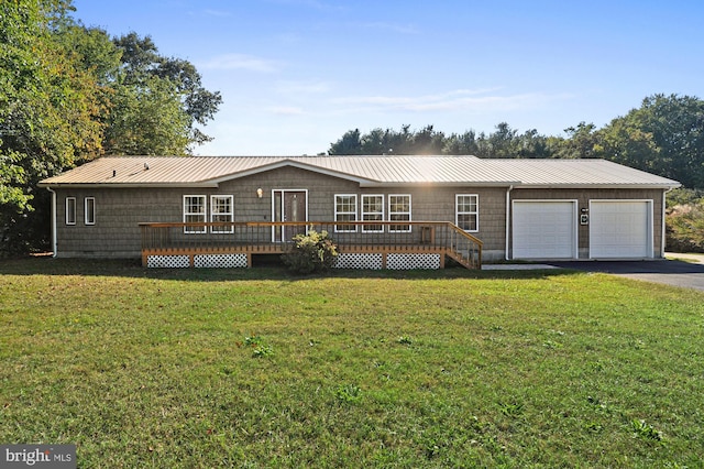 ranch-style house featuring a wooden deck, a front lawn, and a garage