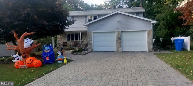 front of property with a front yard and a garage