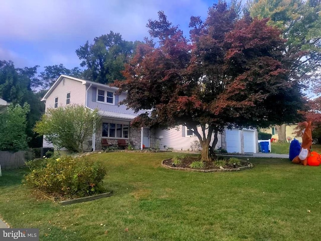 view of front of house with a front lawn and a garage