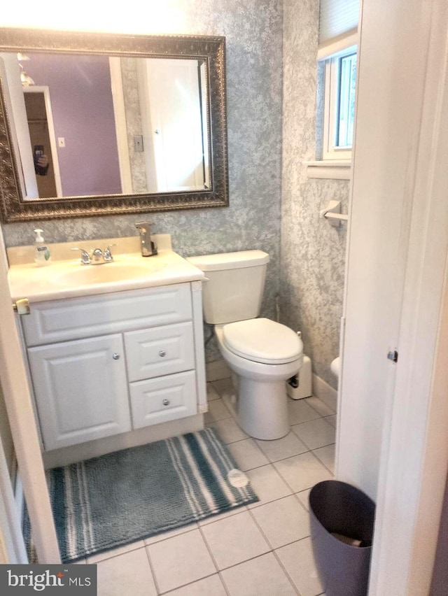 bathroom with vanity, toilet, and tile patterned floors