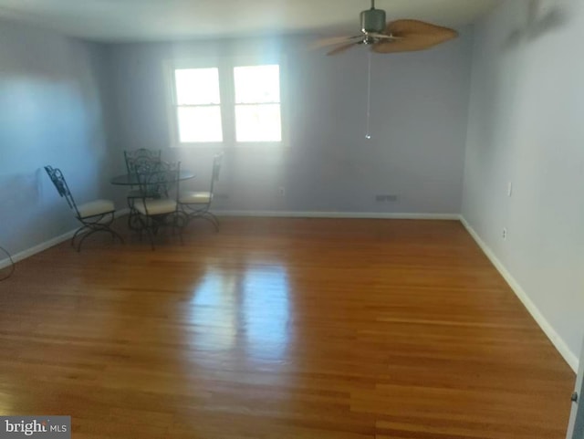 unfurnished room with ceiling fan and wood-type flooring