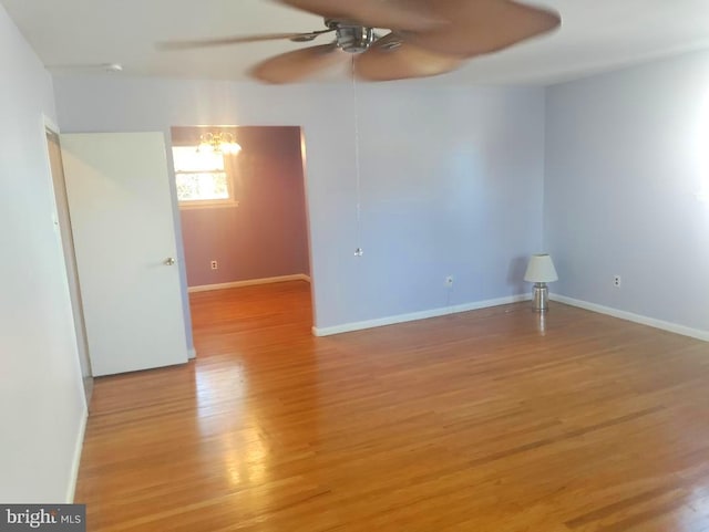 empty room with ceiling fan and light wood-type flooring