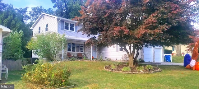 obstructed view of property featuring a front lawn and a garage