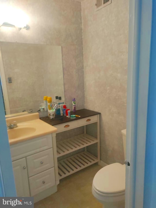 bathroom featuring vanity and toilet