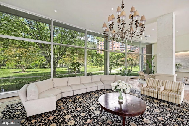 sunroom featuring plenty of natural light and a chandelier