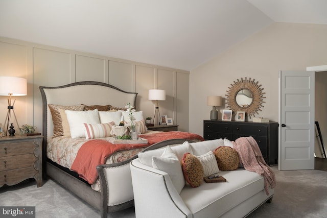 bedroom featuring carpet and vaulted ceiling