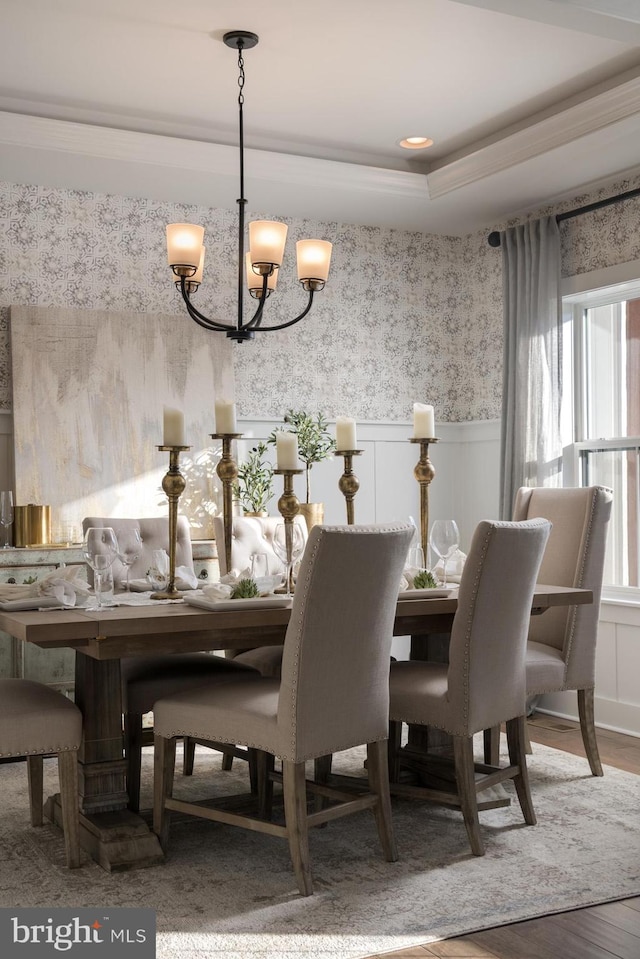 dining space with an inviting chandelier and hardwood / wood-style flooring