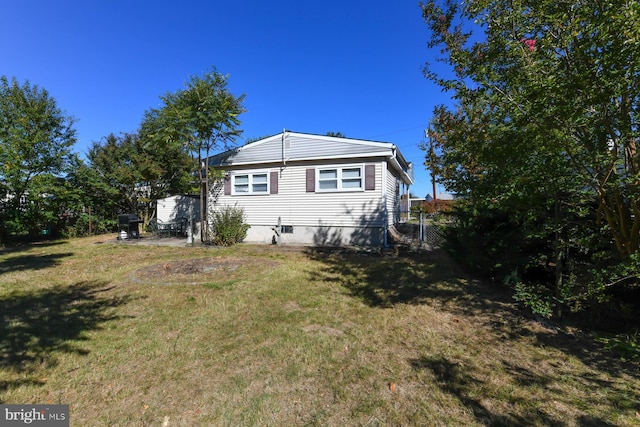 back of house with a lawn