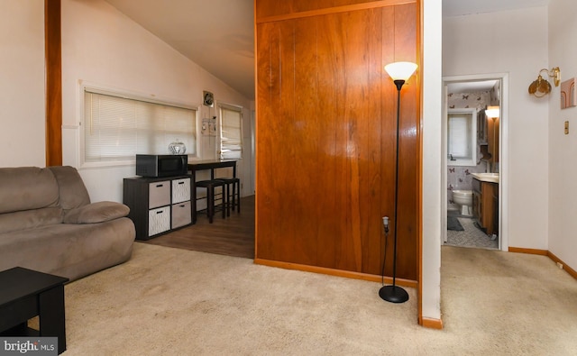 living room featuring carpet and vaulted ceiling