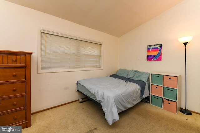 bedroom featuring light carpet and vaulted ceiling