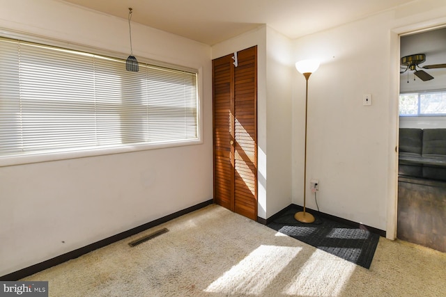 interior space with ceiling fan