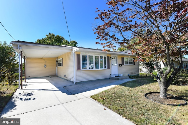 single story home with a carport and a front lawn